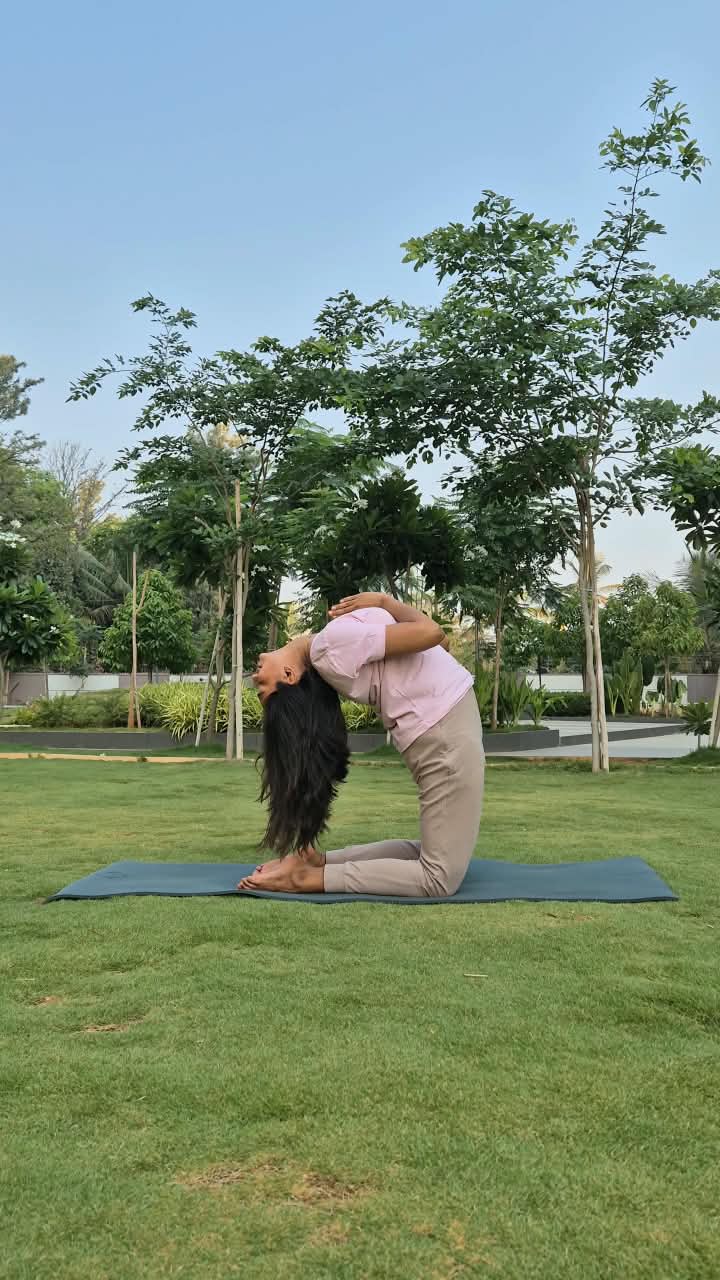 Dhruvi practising a kneeling backbend on a lawn