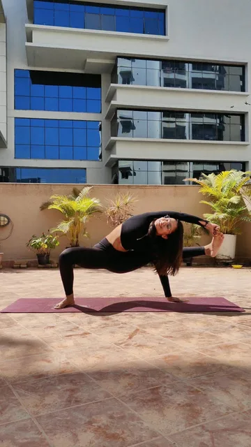 Dhruvi practising an arm balance on a terrace