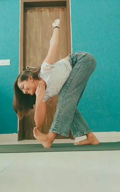 Dhruvi practising a standing twist and forward fold