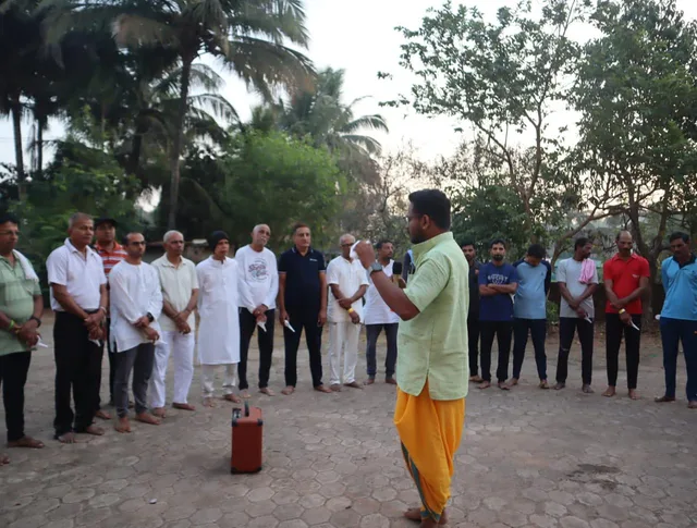 Nikhil addressing participants gathered outdoors in Honnavara