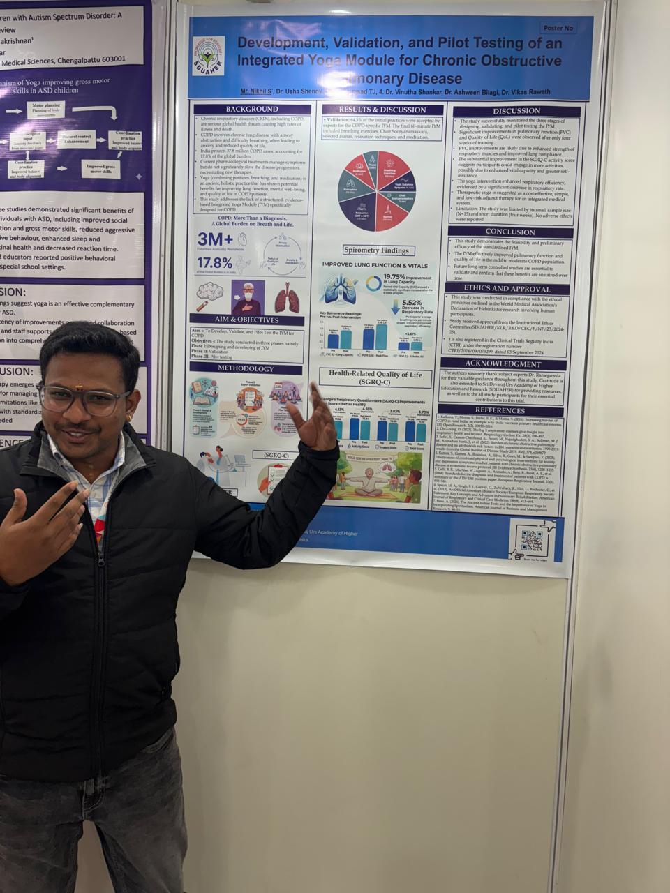 Nikhil standing beside a research poster at S-VYASA
