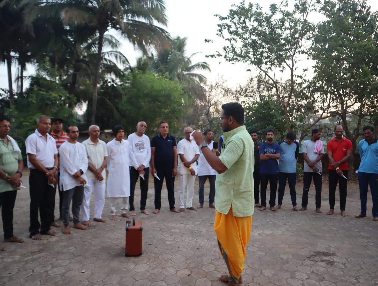 Nikhil addressing participants gathered outdoors in Honnavara